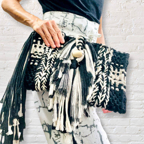 Bound handwoven macrame clutch bag with tassles in black and white