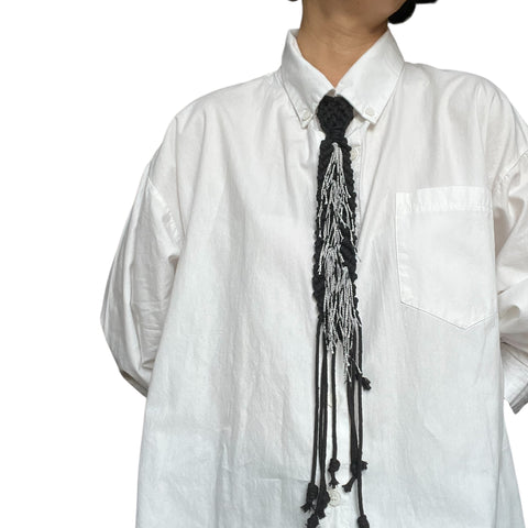 Black Tie with Tassels and Buttoned Up White Shirt